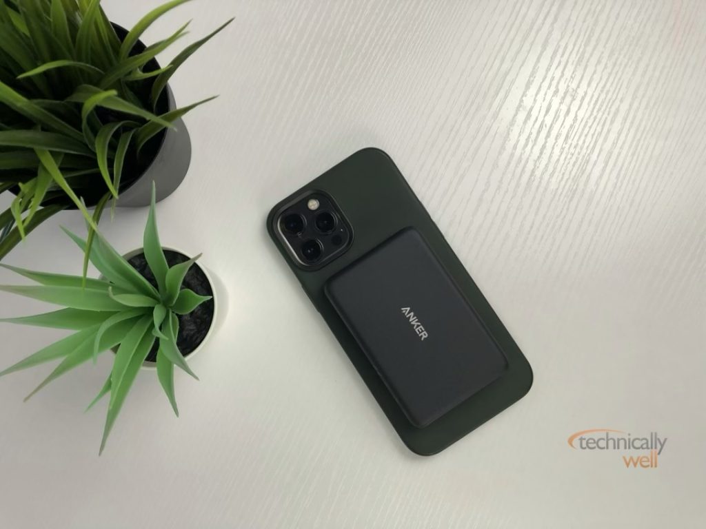 The Anker PowerCore Magnetic 5K Wireless power bank attached to an iPhone 12 Pro Max with silicone case